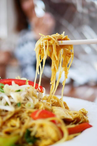 Rice vermicelli noodles up close from a noodle stir fry. Photo by Kate Romeo.