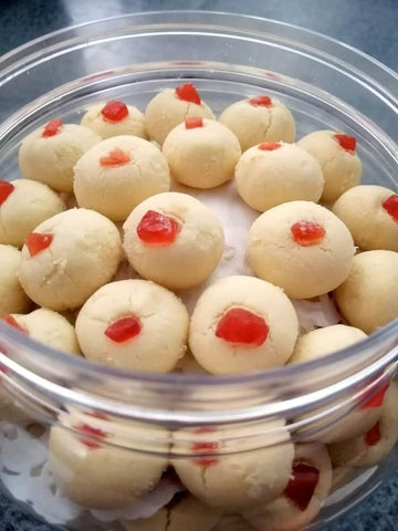 Sugee cookies topped with a hint of glazed red cherry.