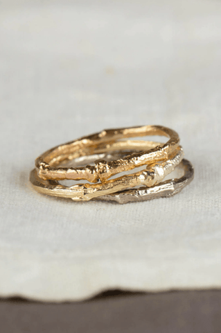 Amanda Coleman's twig ring in solid 18ct yellow, white and rose gold, against a white backdrop