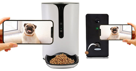 Picture of the Lentek smart pet feeder and Lentek smart treat tosser on a white background. There are two hands each holding a mobile phone with a picture of a pug dog on the screens in the foreground