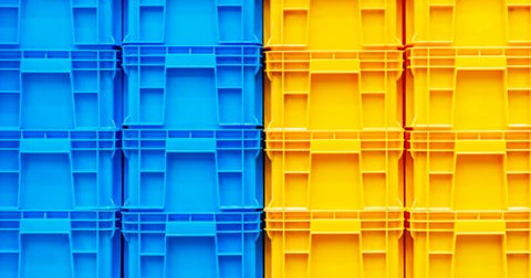 Closeup image of blue and yellow plastic storage totes