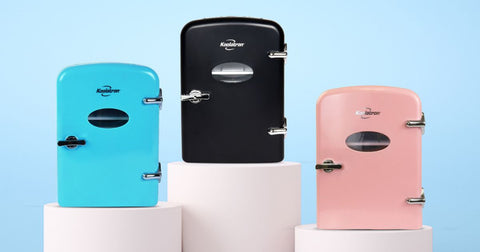 Picture shows the black, aqua, and pink 4L mini fridges closed on white pedestals