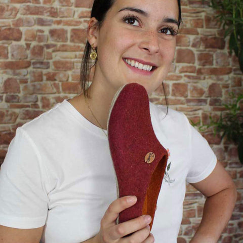 smiling-girl-is-holding-a-wool-slipper