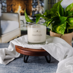 gratitude candle in a cozy living room setting