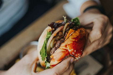 person holding burger