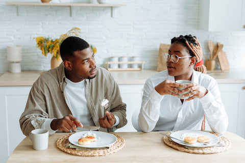 A photo of a working couple eating breakfast