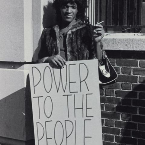 Photo of Marsha P. Johnson with a sign that says "Power to the People"