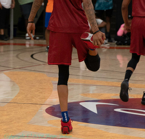 Basketball Player wiping dust of their shoes for grip