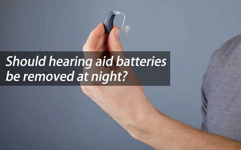 Should hearing aid batteries be removed at night