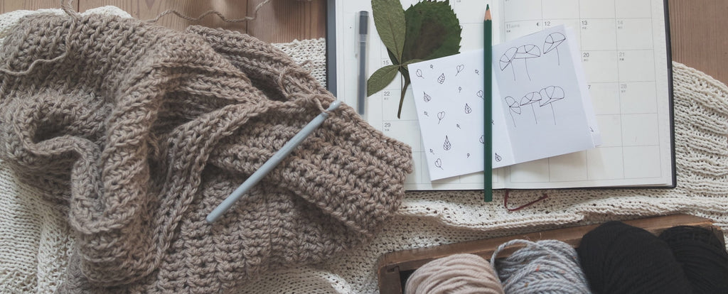 a wool product that is woven and has a notebook next to it