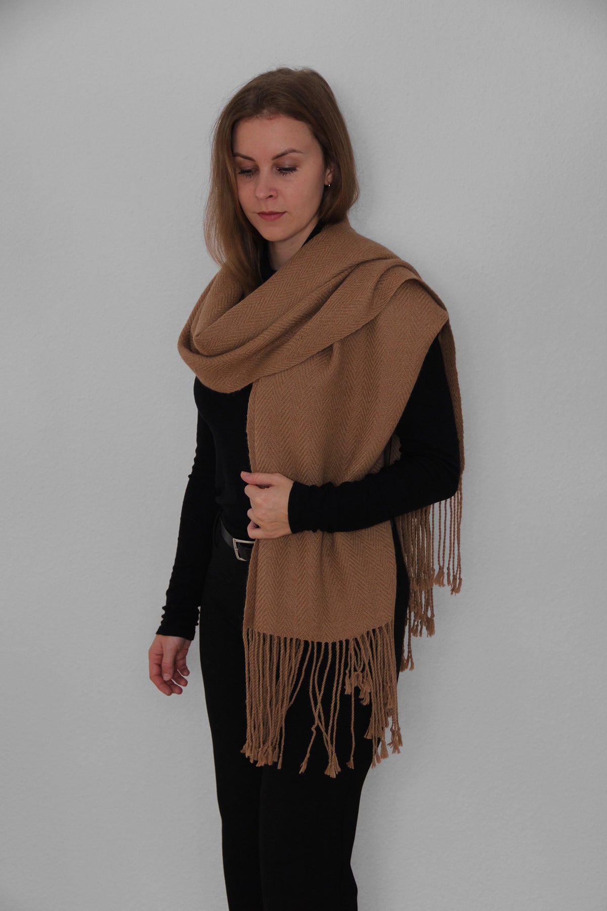 A woman using a one colour brown alpaca scarf