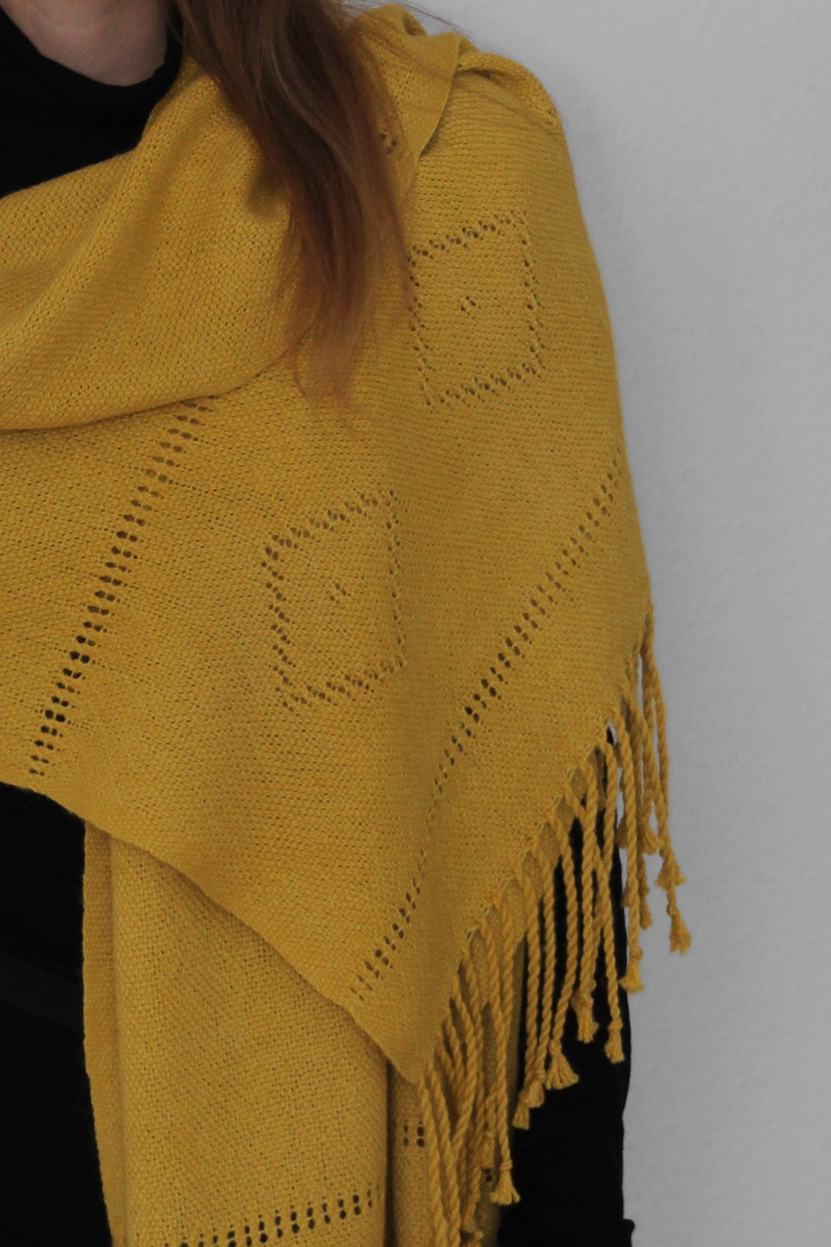 A yellow alpaca scarf with a lace pattern