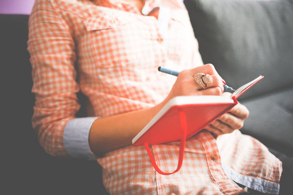 Woman writing in her journal 