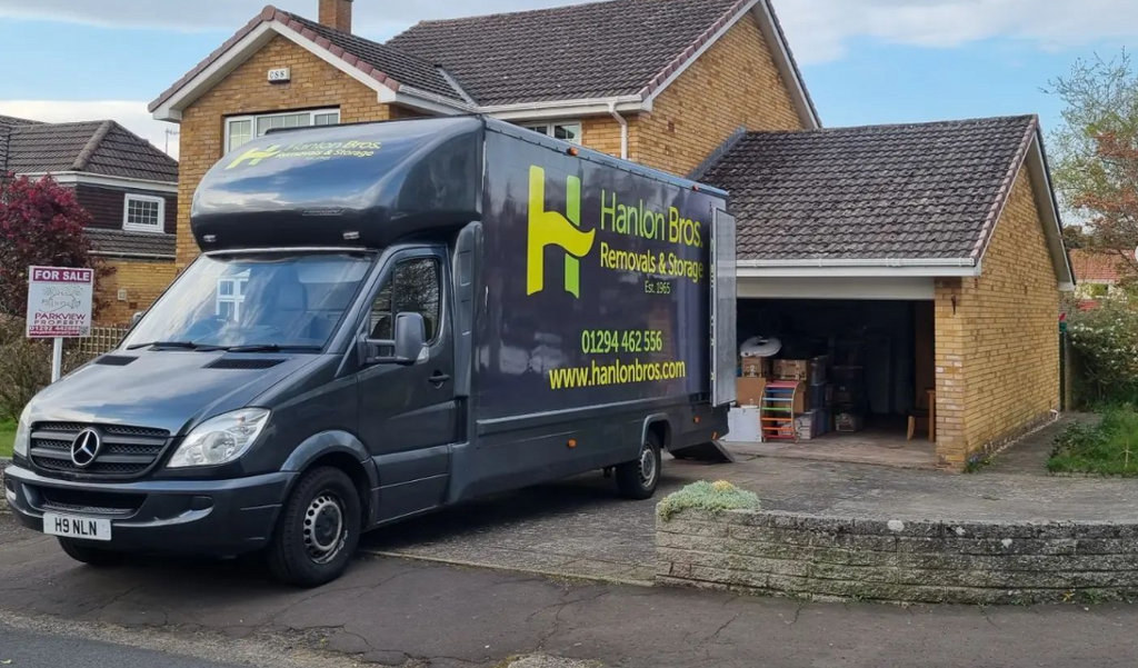 A Hanlon van outside a home.