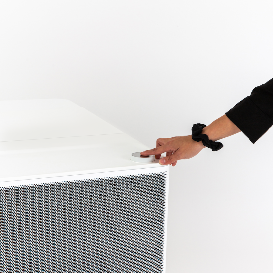 A woman pressing the dial of a Gradient heat pump