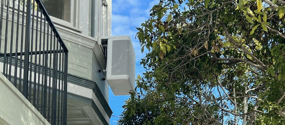 Window heat pump hangs from a window