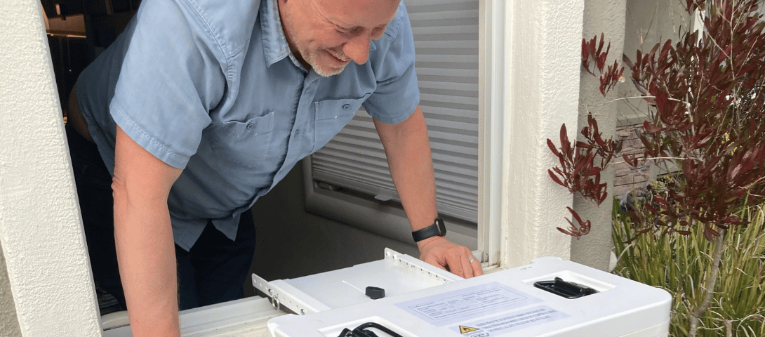 A man smiles at a Gradient window heat pump