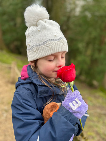 Eva smelling a rose
