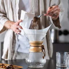 Pour coffee grounds into chemex