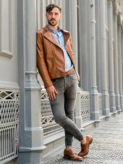 men-tan-leather-jacket-with-grey-chinos-and-blue-shirt