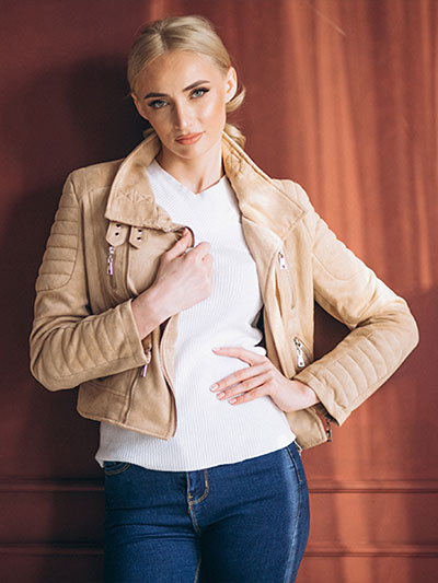 women in beige leather jacket with blue jeans