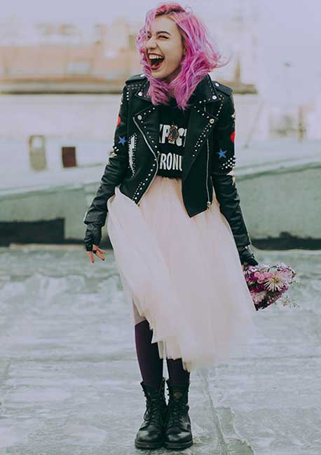 womens black studded leather jacket with beige dress and long boots