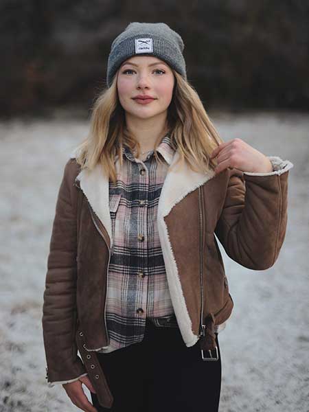 Women-brown-fur-leather-jacket-with-checkered-shirt-and-black-pants