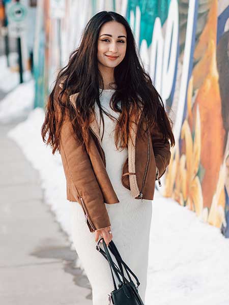 Women-brown-suede-leather-jacket-with-white-dress-and-leather-purse