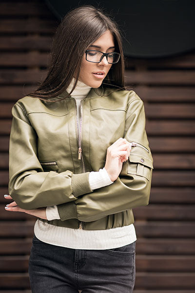 women-green-leather-jacket-with-grey-jeans-and-white-turtle-neck-top