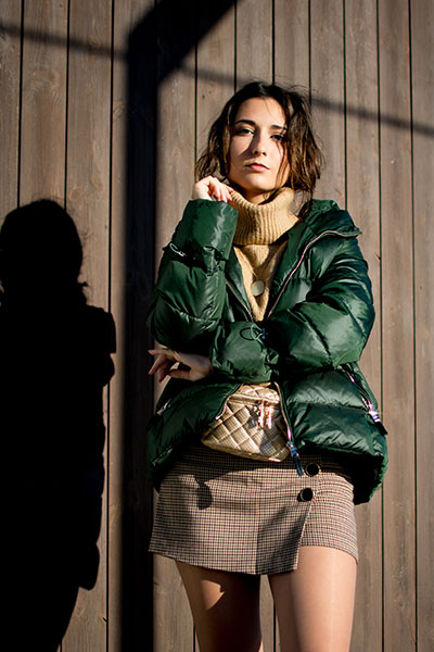 women-green-leather-jacket-with-checkered-skirt-and-high-neck-top
