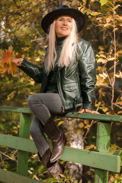 women-green-leather-jacket-with-grey-jeans-and-leather-boots