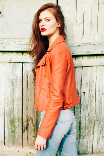 Women-orange-leather-jacket-with-high-rise-jeans-and-stiletto-heels 