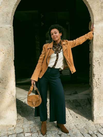women-tan-leather-jacket-with-bell-bottoms-and-white-shirt