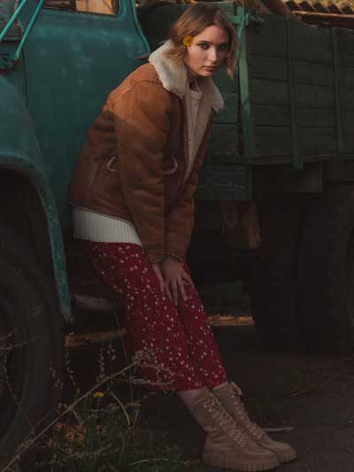 women-tan-leather-jacket-with-printed-skirt-and-suede-shoes