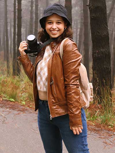 women-tan-leather-jacket-with-blue-jeans-and-brown-sweater