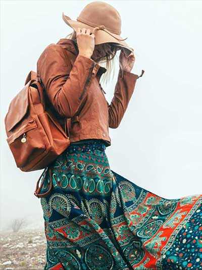 women-tan-leather-jacket-with-boho-skirt-and-brown-hat