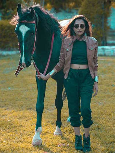 women-tan-leather-jacket-with-black-sweat-pants-and-riding-boots