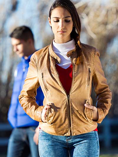 women-tan-leather-jacket-with-blue-jeans-and-white-high-neck