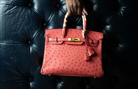 A Hermès Birkin bag against a leather backdrop.