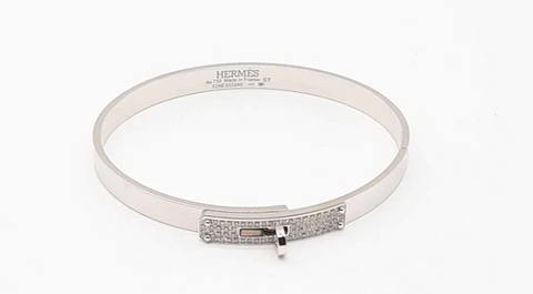 A Hermès Bangle Bracelet is on display.