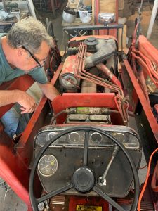 Jeff Nania working under the hood of a tractor