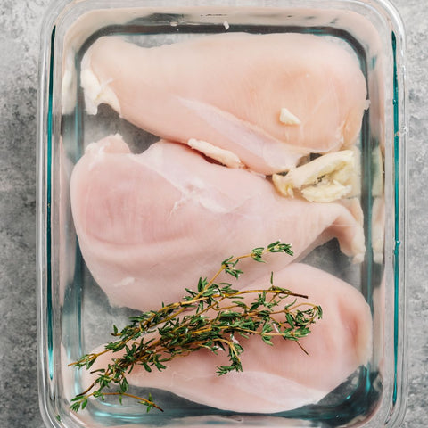 raw chicken in a glass container