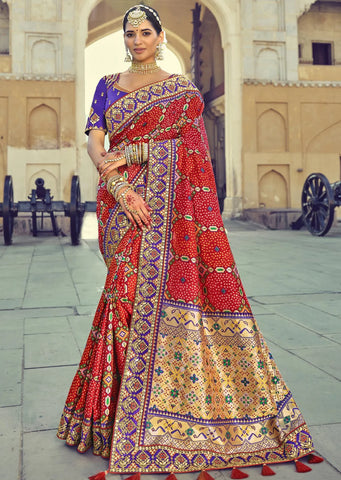 woman standing in red bridal patola saree