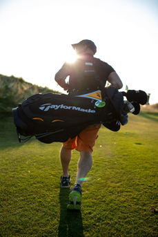 Golfer walking along the fairway