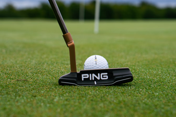 A PING putter lining up for the pin