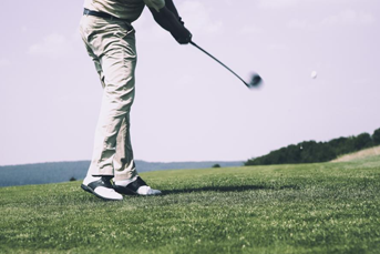 A golfer swinging his club with a new shaft