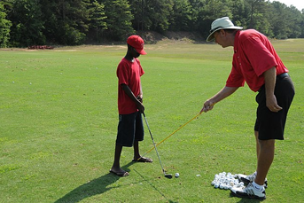 A child learning to play golf