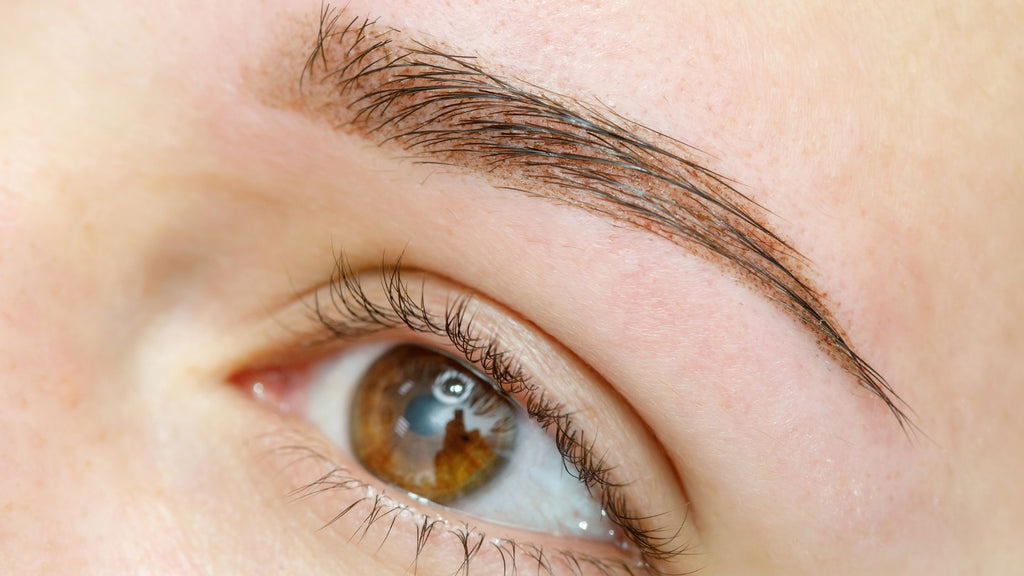 Lady after receiving an eyebrow tattoo.