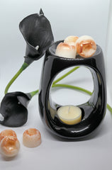 Black wax burner and mini dome shaped wax melts next to black lily