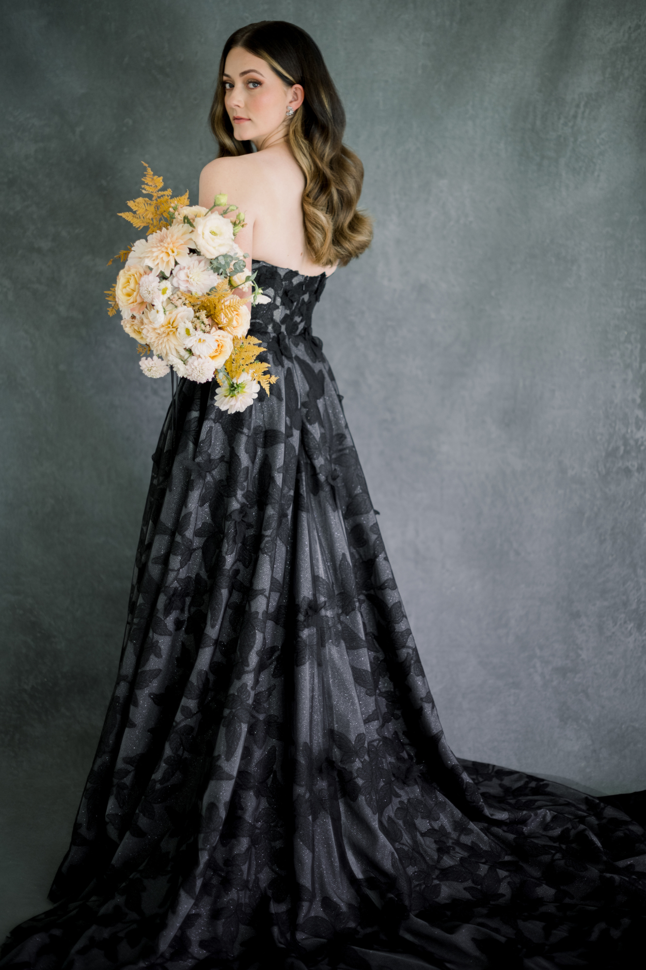 Model wears black wedding dress in a magazine photoshoot.